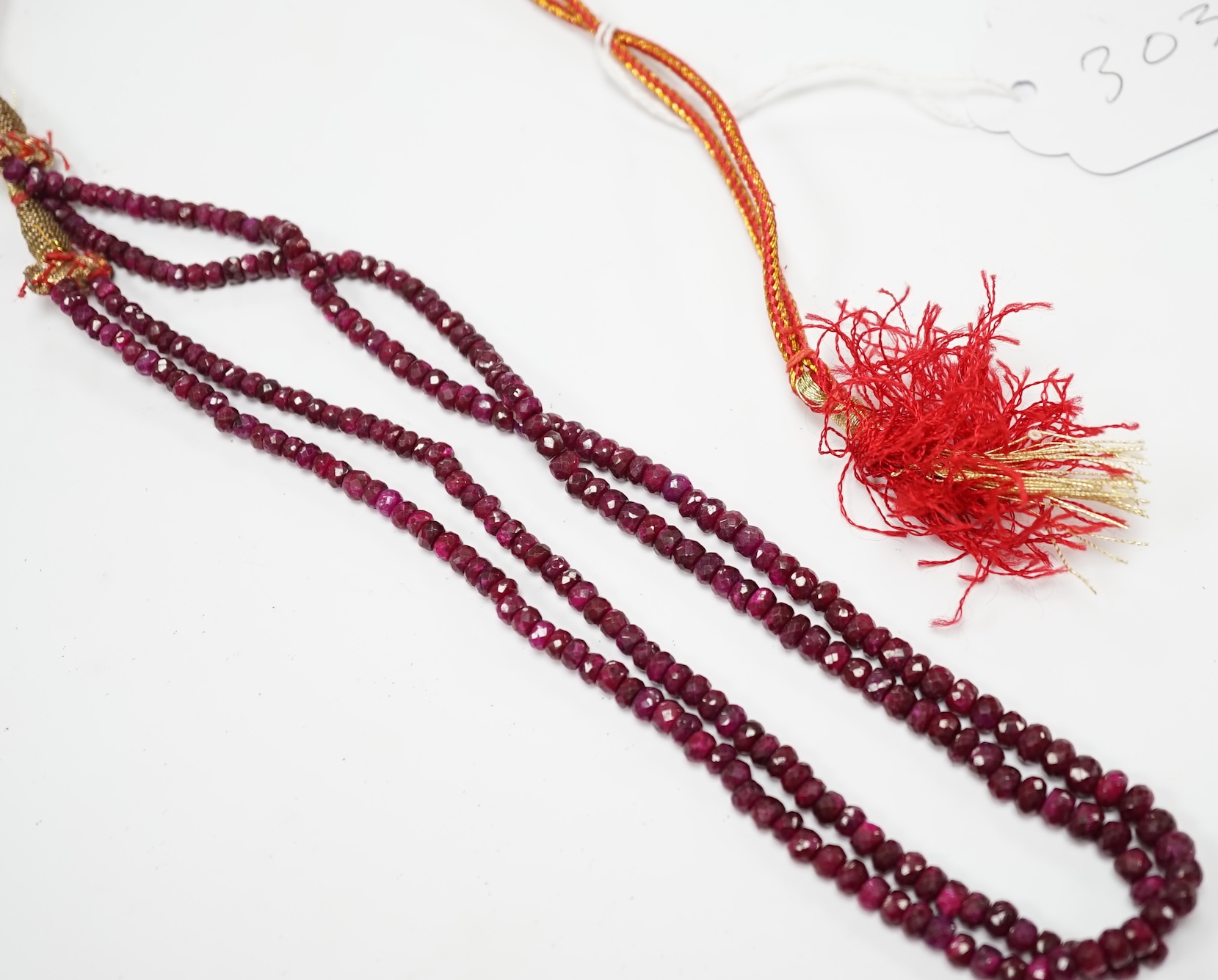 An Indian double strand facetted ruby bead necklace, ruby section only 38cm. Condition - fair